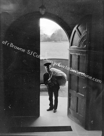 POSTMAN AT DOORWAY